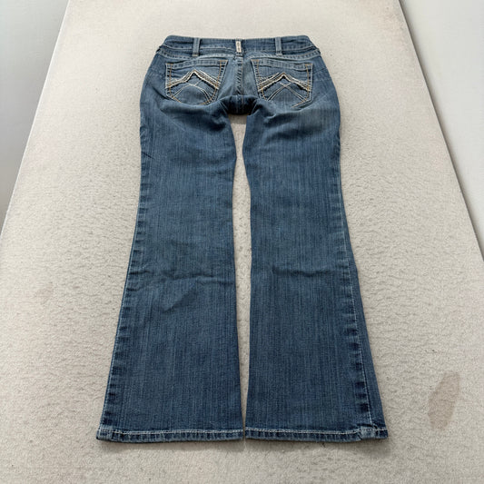 Women's blue faded denim bootcut jeans featuring decorative embroidered back pockets and a classic flare leg silhouette.