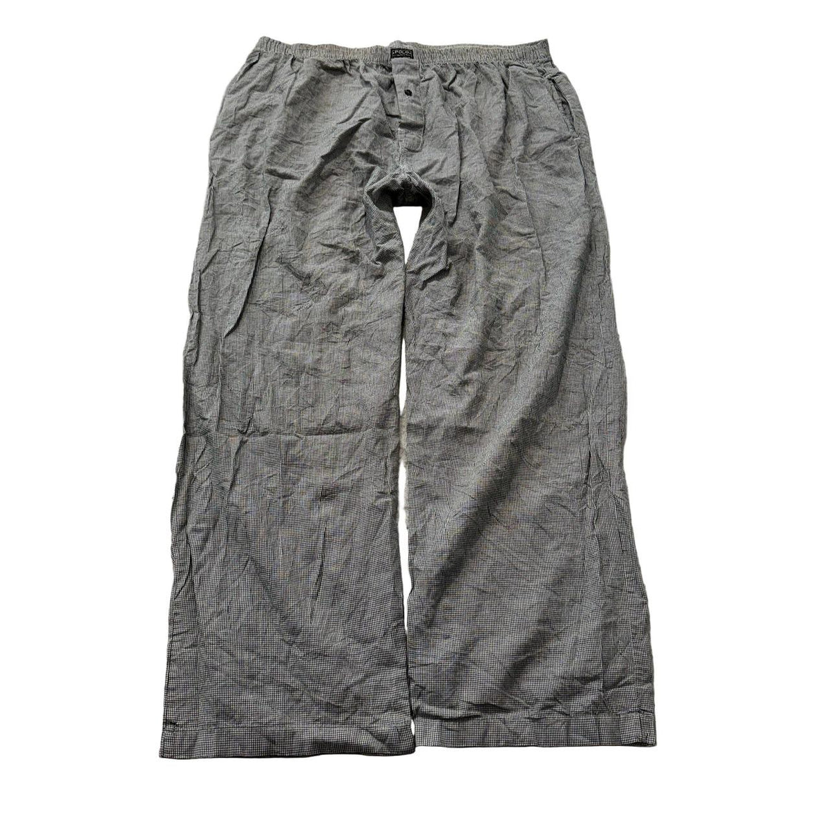 Vintage Polo by Ralph Lauren Men's Grey Pajamas with Button Fly Closure Size L is a classic sleepwear piece that reflects the brand's renowned preppy and elegant aesthetic. The set is likely crafted from a soft and comfortable fabric, such as cotton or a